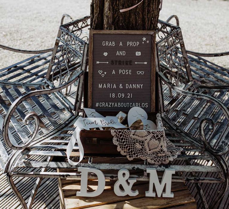 Photo Booth station with props in courtyard at stone barn wedding reception in the Cotswolds