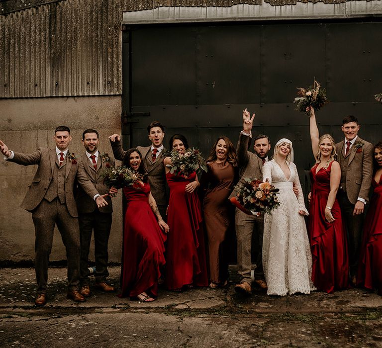 Lyde Court autumn wedding with wedding with groomsmen in brown suits and bridesmaids in red satin bridesmaid dresses 