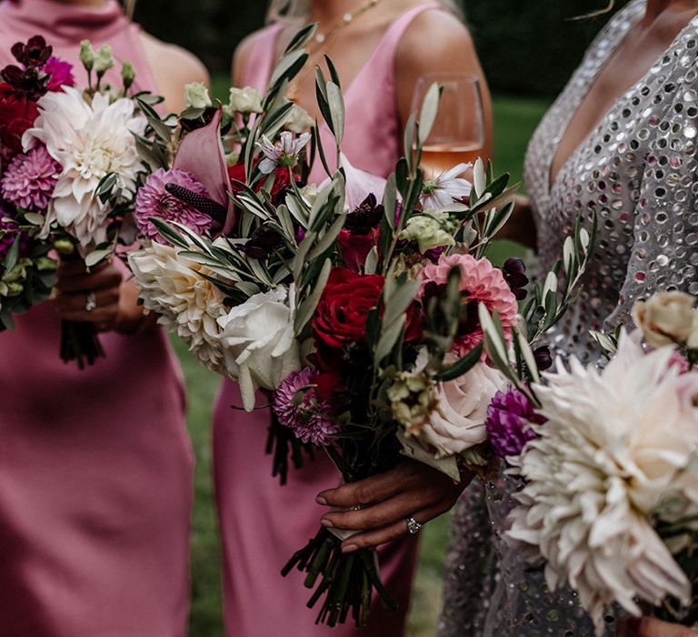 Wedding bouquets with pink, white and red dahlias, roses and foliage 