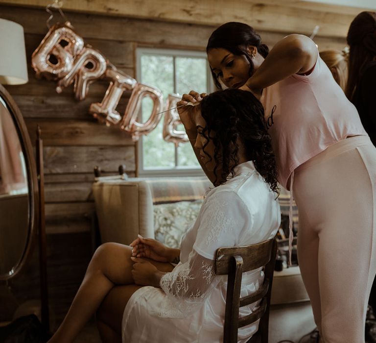 Bride has her makeup done on the morning of her wedding day