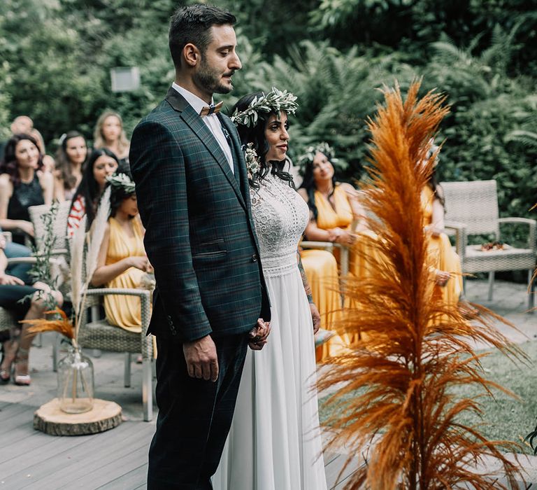 Bride & groom stand at the altar on their wedding day 