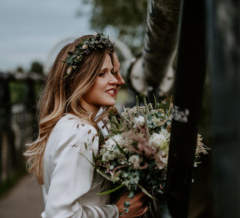 Bride holds floral bouquet on her wedding day