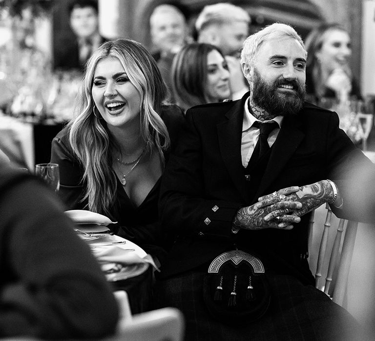 Bridesmaid Jamie Genevieve with husband in kilt for autumnal Scottish wedding