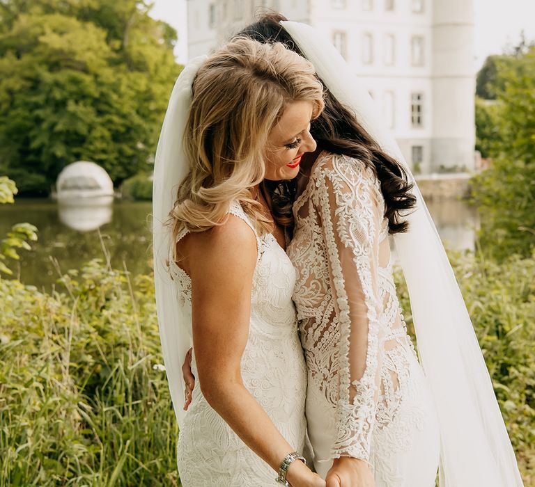 Brides share an intimate embrace on their wedding day 