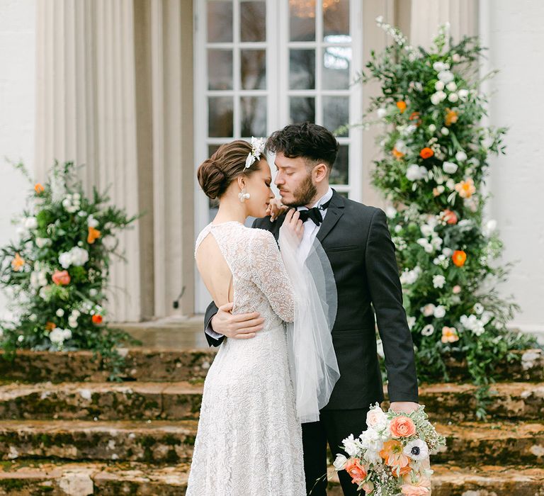 Holesfoot blacktop wedding with groom in a black tuxedo embracing his bride in an embellished wedding dress 