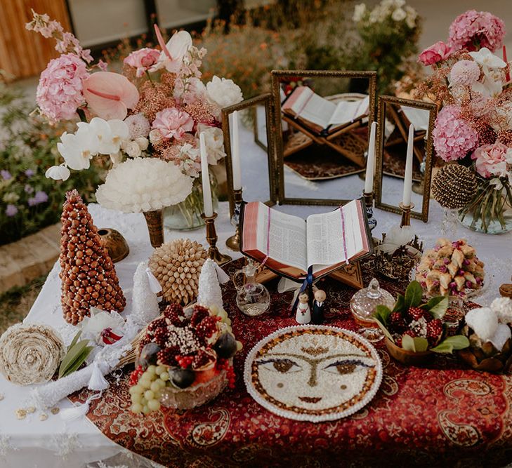 Sofreh Aghd table with traditional offerings and scripture of the couples choosing 