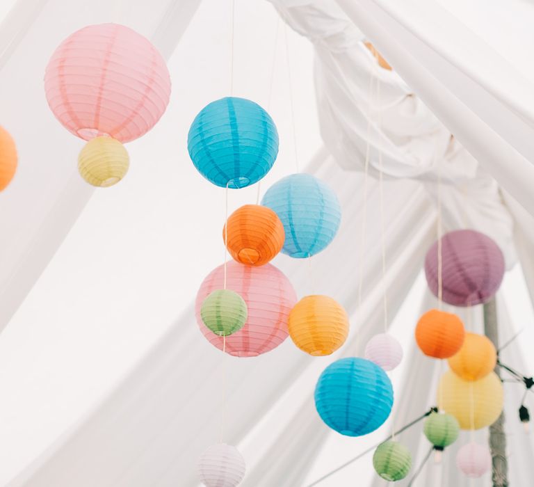 Colourful hanging lanterns from marquee 