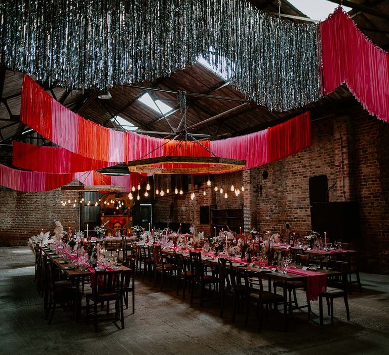 Pink and red and silver wedding DIY streamer decorations for the industrial style wedding venue 