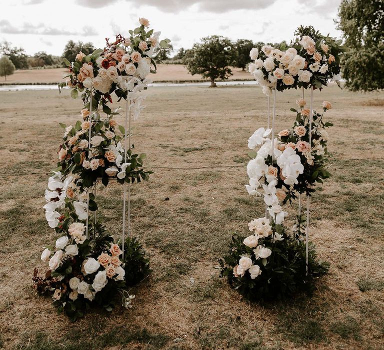 Rose and orchid flower columns with white and peach flowers 