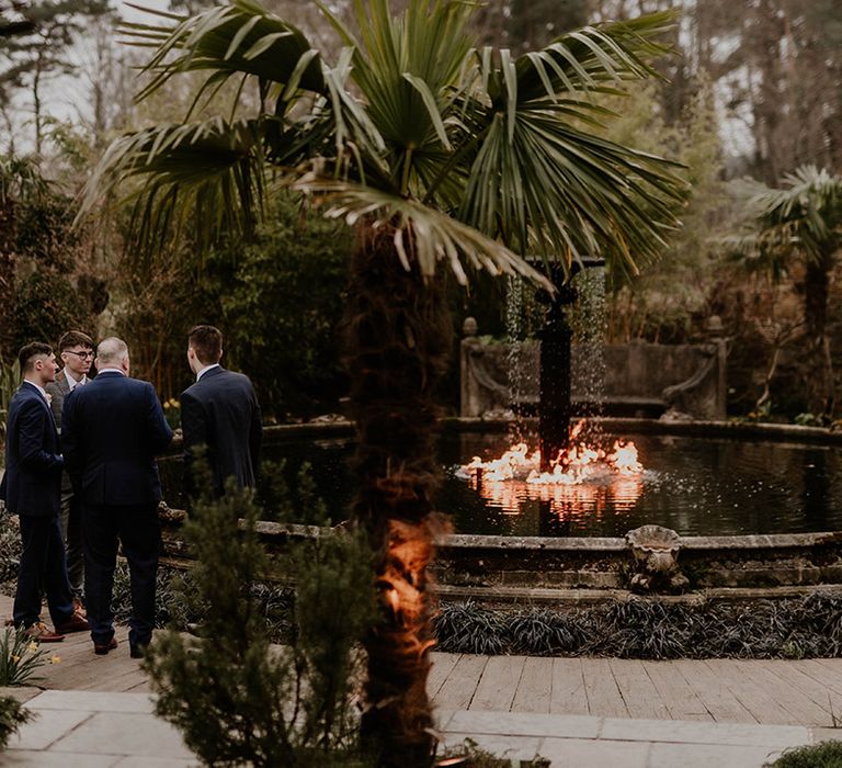 Wedding guest gather in front of Le Petit Chateau fountain