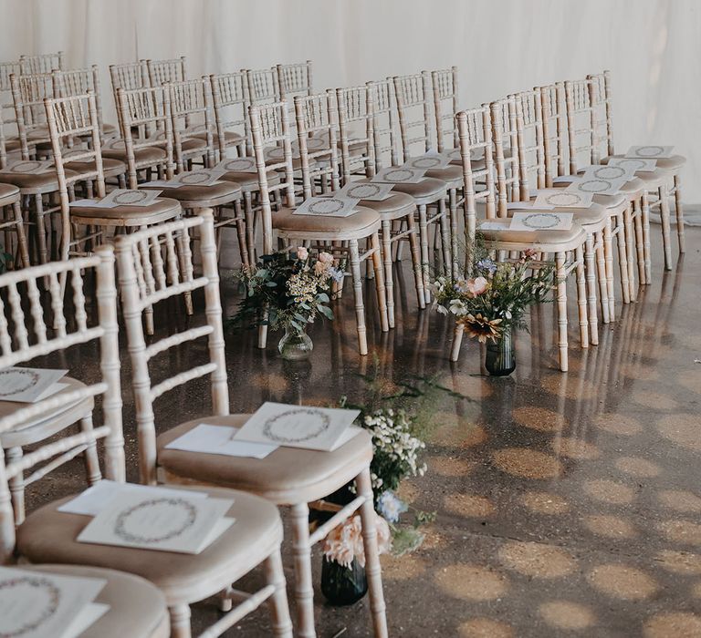 Homemade floral arrangements line wedding aisle at Trinity Buoy Wharf