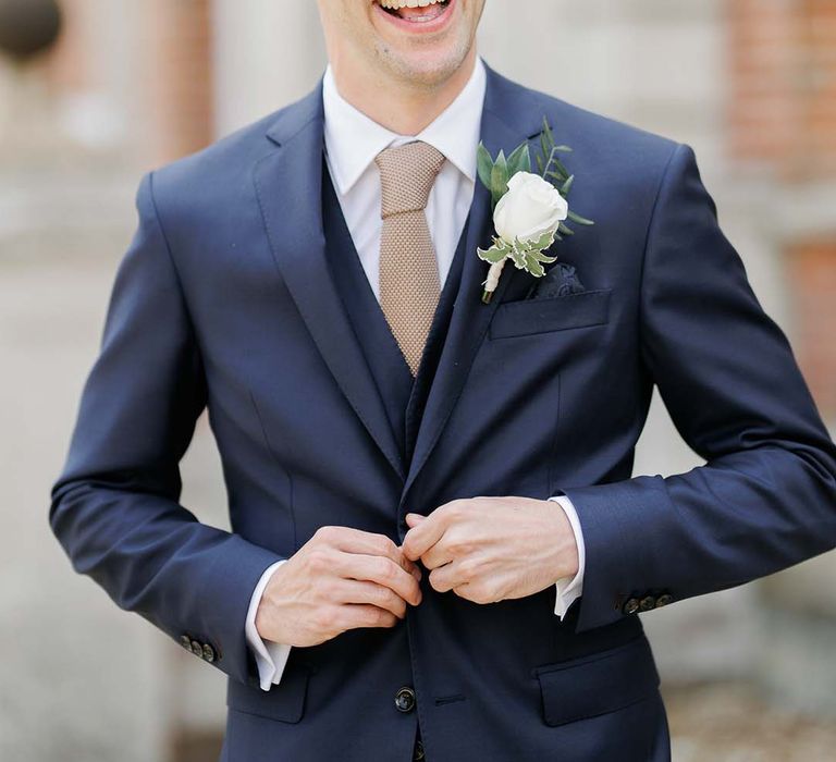 Groom in a navy three-piece wedding suit 