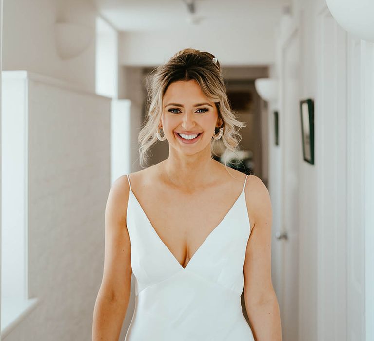 Bride in a v-neck satin slip wedding dress for a classic and timeless Elms Barn wedding 