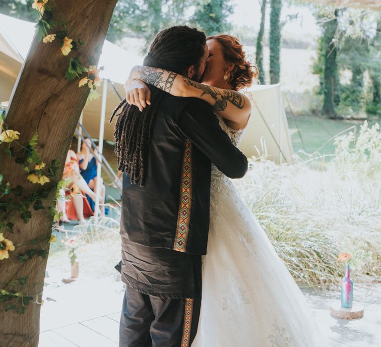 bride and groom kiss during the wedding ceremony at Deer's Leap Retreat in Devon 