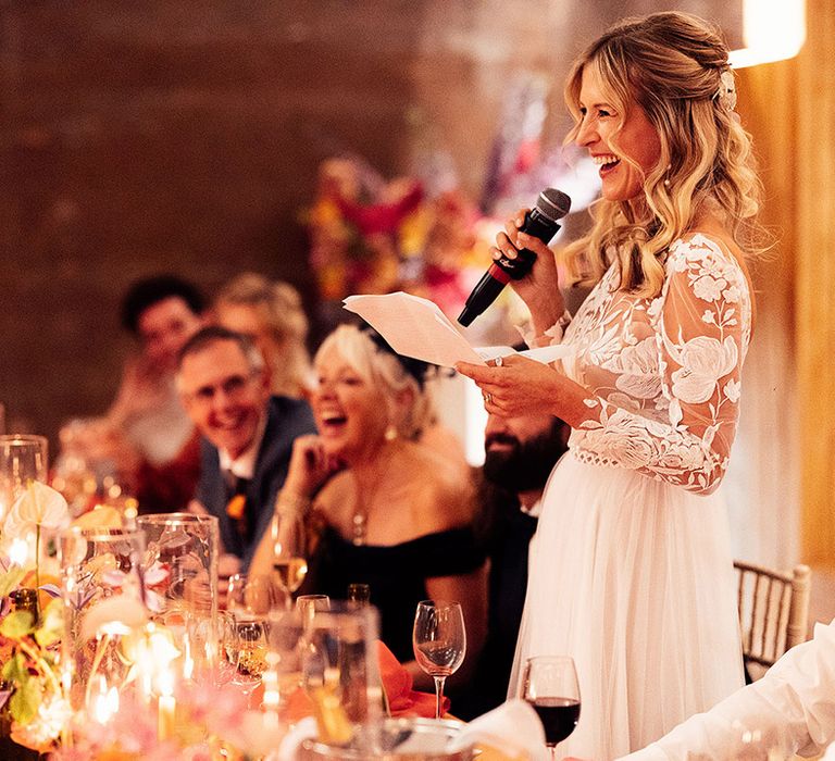 Bride stands and performs a bridal speech at her wedding 