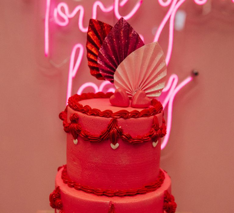 Hot magenta pink with retro styled icing and sparkly cake topper for gender neutral wedding with retro theme 