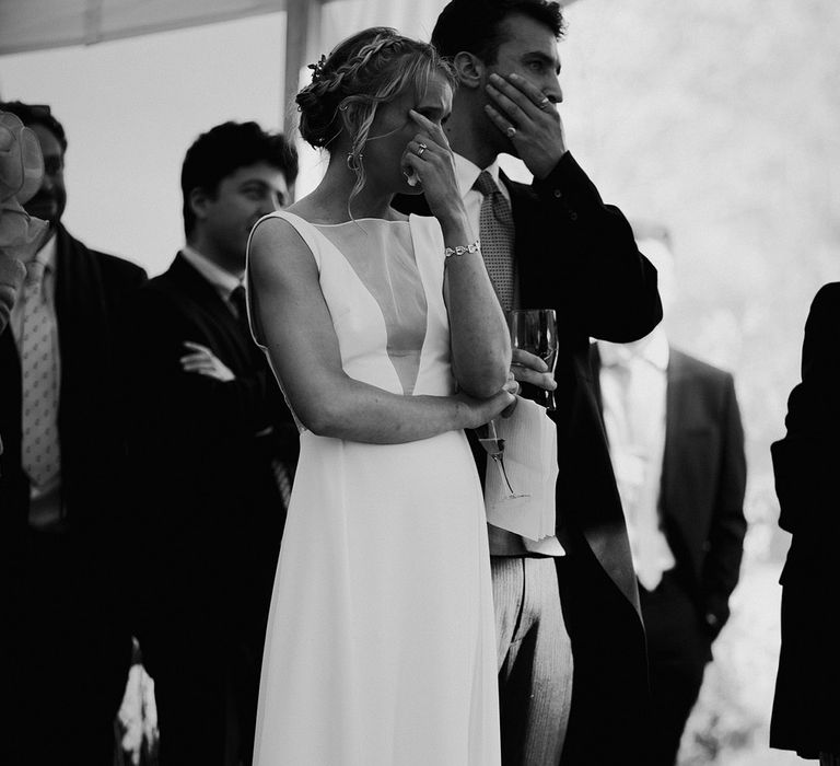 The bride and groom cry at the wedding speeches at there reception 