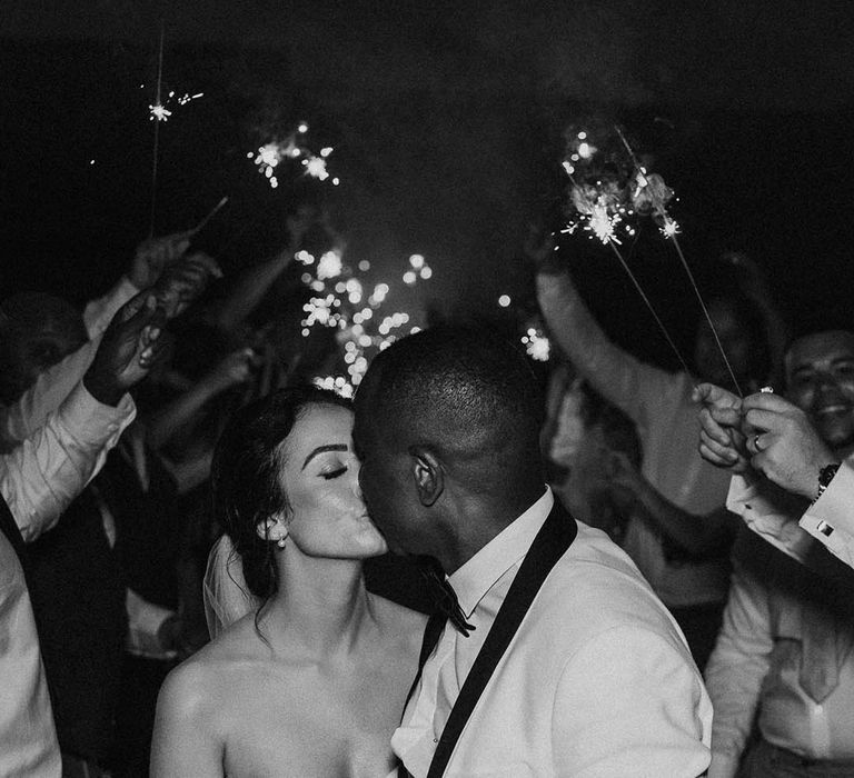 Groom kissed bride during sparkler exit at Crumplebury wedding