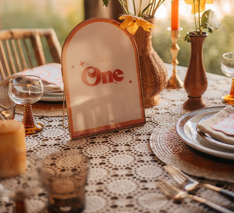 Orange and white retro arched wedding table number sign on wedding table 