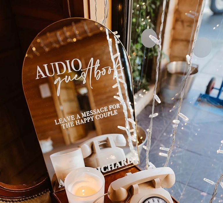 Audio guest book with vintage and retro white rotary dial phone and mirror sign 