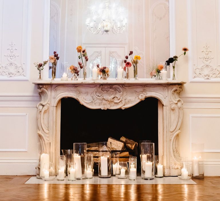 Flower stems in cases decorating the fireplace