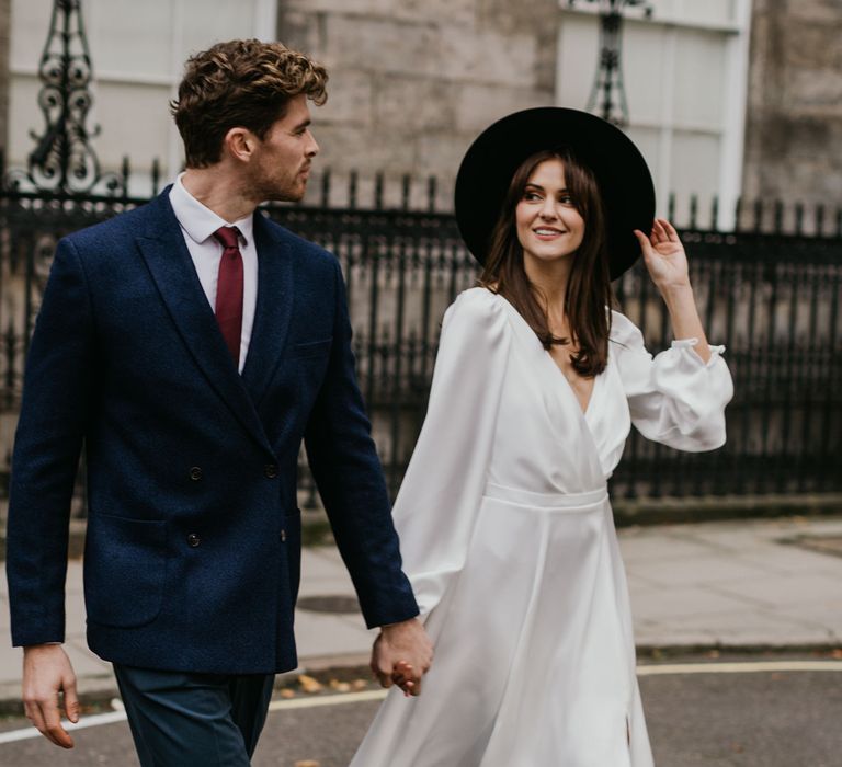 Bride and groom crossing the road at London intimate wedding 