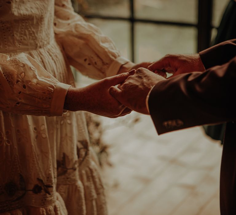 Bride and groom holding hands 