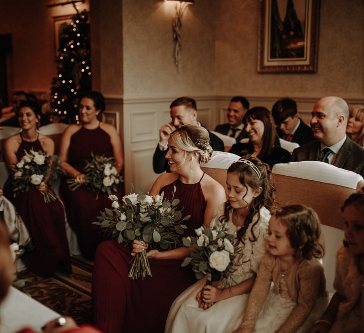 Christmas themed winter wedding with burgundy wedding dresses