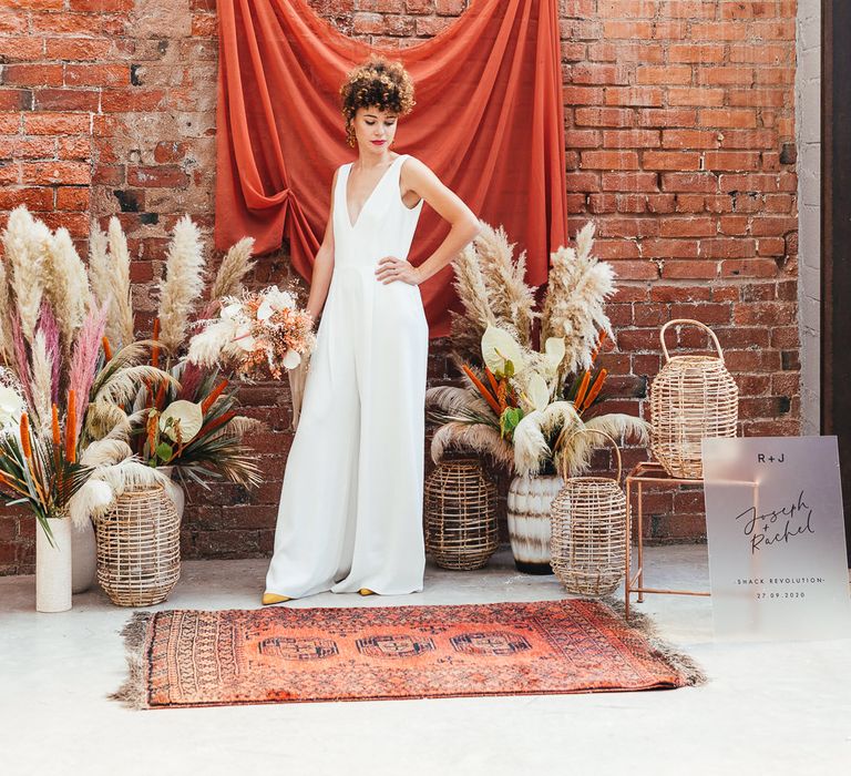 Bride with curly hair and bridal jumpsuit