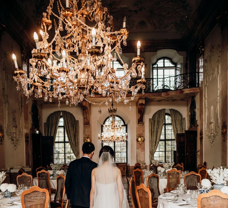 Bride and groom entering their intimate wedding reception at Hotel Schloss Leopoldskron, Salzburg, Austria