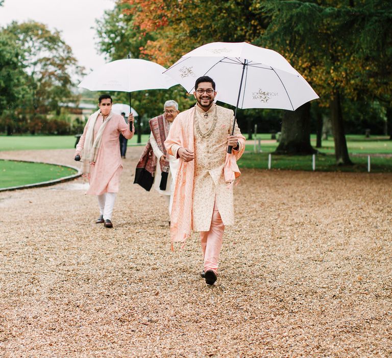 Groom in pink Indian suit for Hindu ceremony at Northbrook Park 