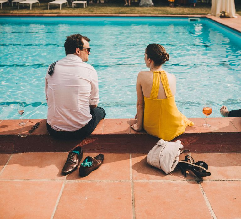 Wedding guests sat by the poolside for Tuscany Italy Wedding in Summer