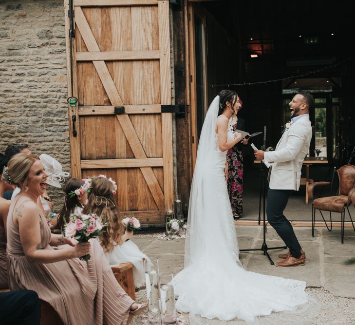 Bride and groom laugh during wedding ceremony