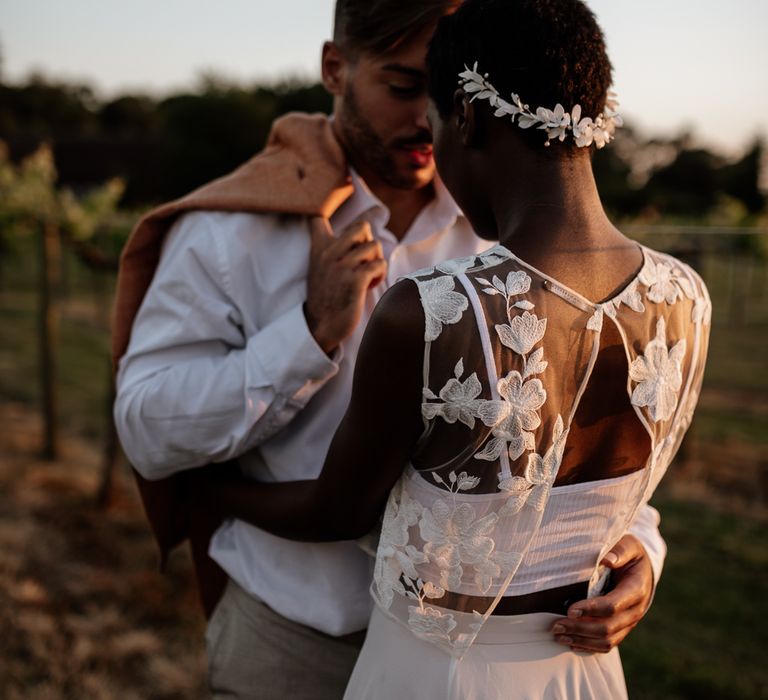 Golden hour portrait with black bride with short hair in lace top and white headdress