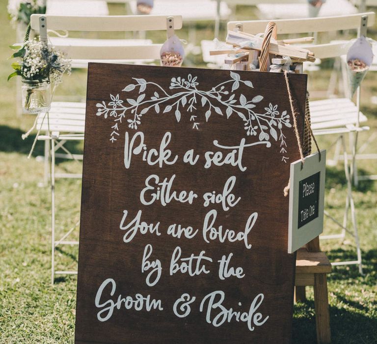 Pick a seat wooden sign for the outdoor wedding ceremony