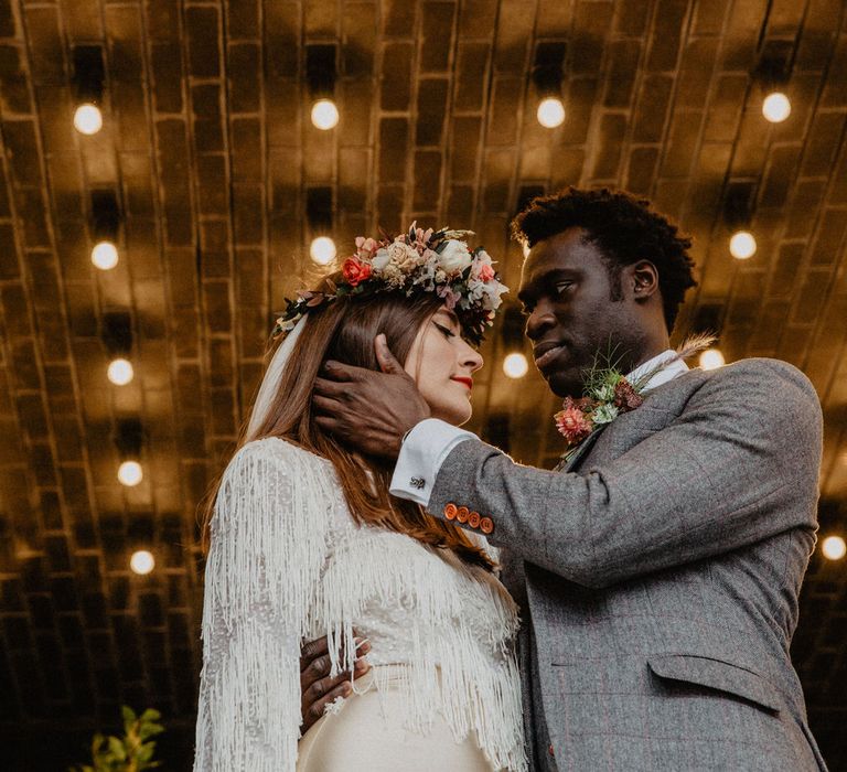 Wedding couple kiss outside of old cinema