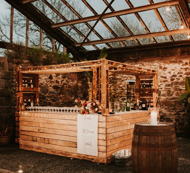 Wooden palette bar area decorated with fairy lights 