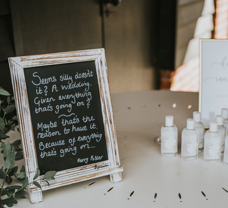 Hand sanitiser next to chalk wedding sign of Harry Potter quote  