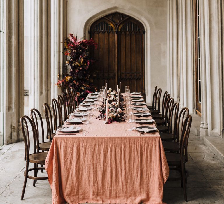 Banquet table at Ashridge House with walnut chairs, dusky pink table cloth and floral table runner flowers 