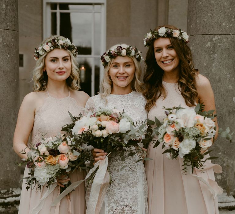 Bride in Grace Loves Lace wedding dress and single tier cathedral length veil stands with bridesmaid in pink silk dresses holding pink and white rose bouquets at Drenagh Estate Wedding