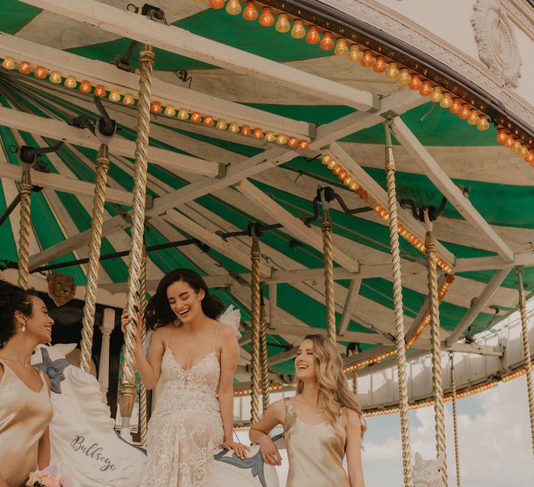 Wedding party sitting on the carousel at Preston Court wedding venue 