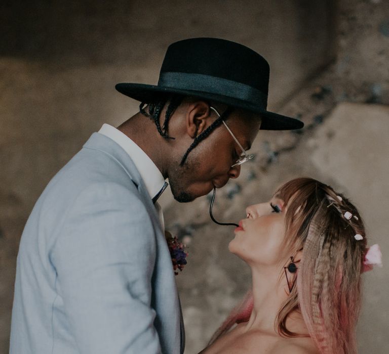 Bride and groom sharing a liquorish lace at candy inspired inspiration shoot 