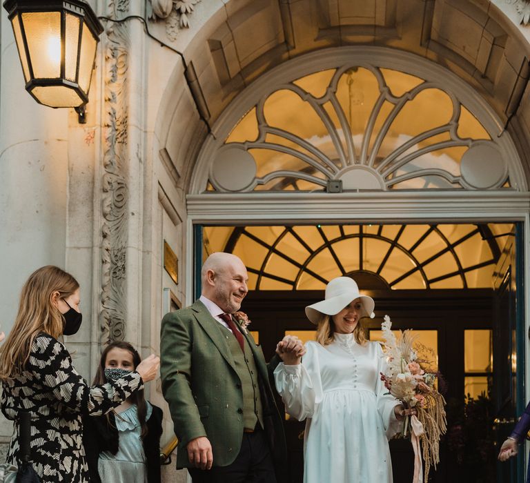 Bride & groom leave Chelsea Town Hall after wedding ceremony