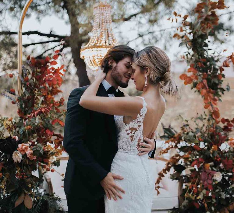 Bride in low back lace wedding dress with groom at intimate elopement