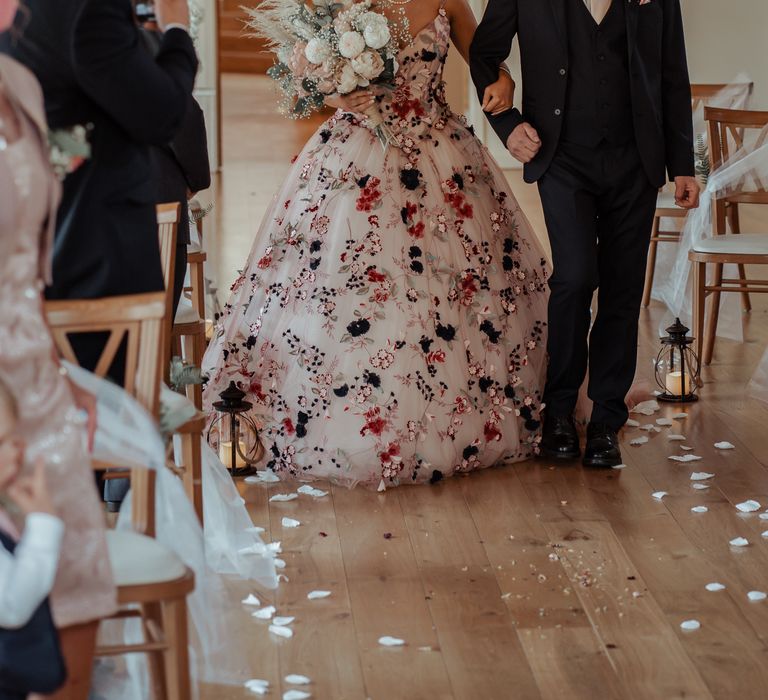 Bride walks down the aisle with father on her wedding day