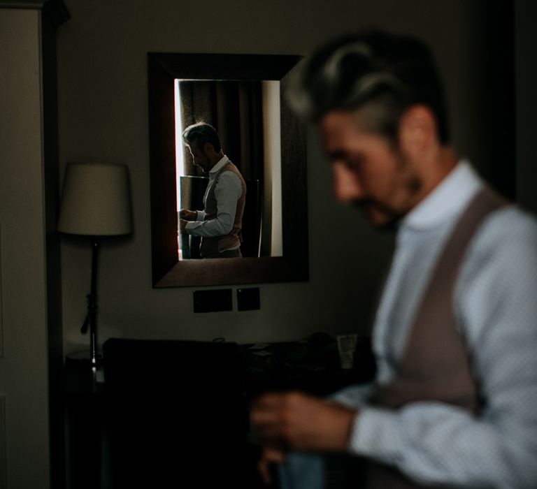 Reflection of groom wearing Shelby & Sons shirt and light brown Moss Bros waistcoat in mirror at Hotel du Vin Harrogate before Harrogate wedding