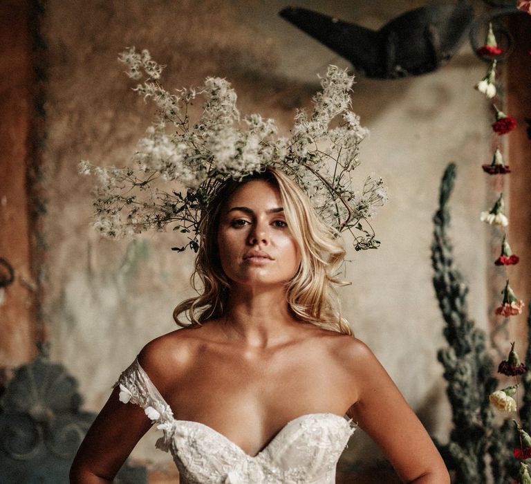 Boho chic bride wearing an abstract wildflower wedding headpiece, and strapless wedding dress with mesh skirt