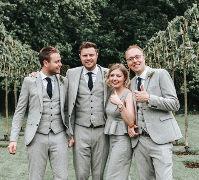 Groom with his best woman and ushers in pale grey wool wedding suits and jumpsuit 