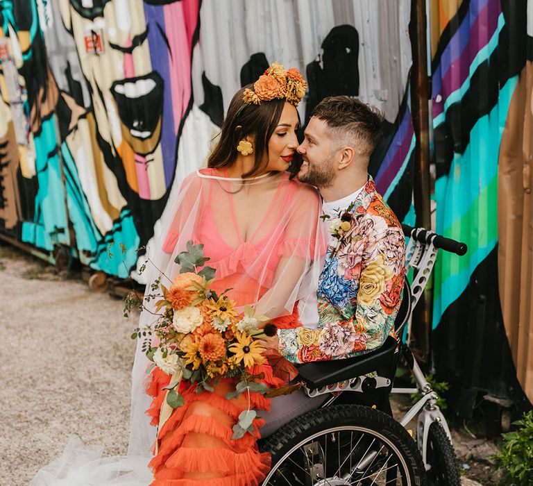 Intimate wedding party portrait of interabled couple at their Shoreditch elopement with bride in a coral wedding dress and Frida Kahlo flower crown 