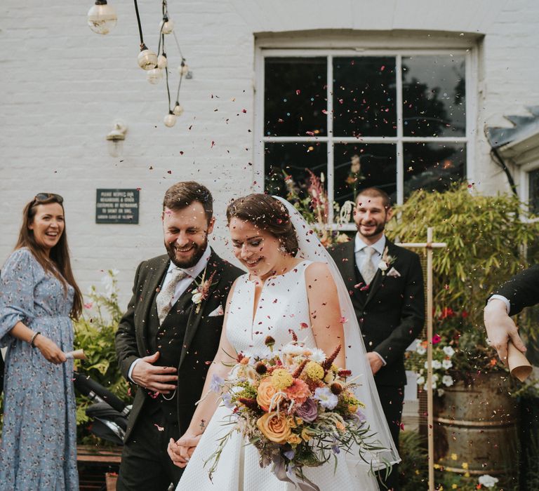 Confetti moment for bride and groom